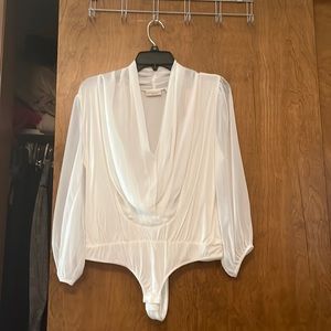From Evamendes collection a whit bodysuit vary elegant for any occasion